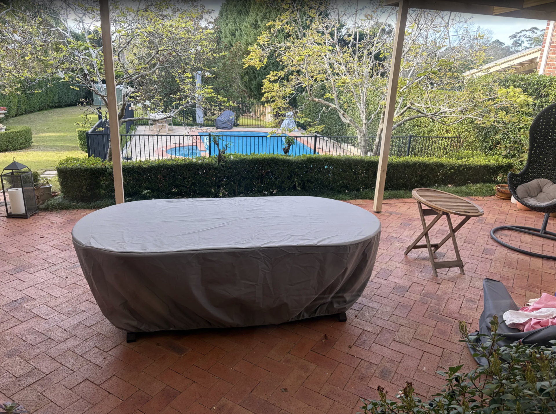 Custom made oval patio table cover in gray fitted on a patio table – The Cover Company USA